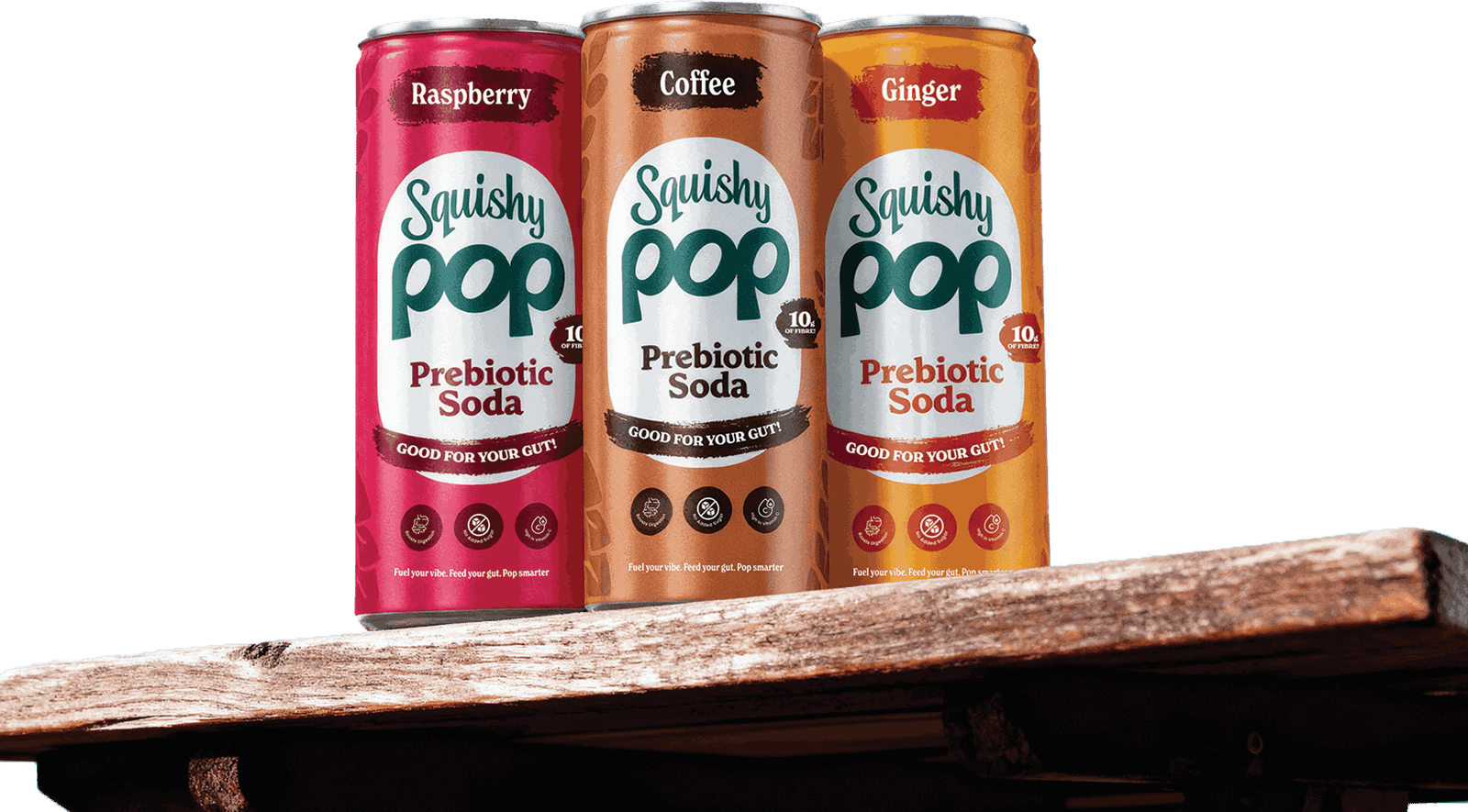 Cans of Squishy Pop Raspberry, Coffee and Ginger on a wooden table